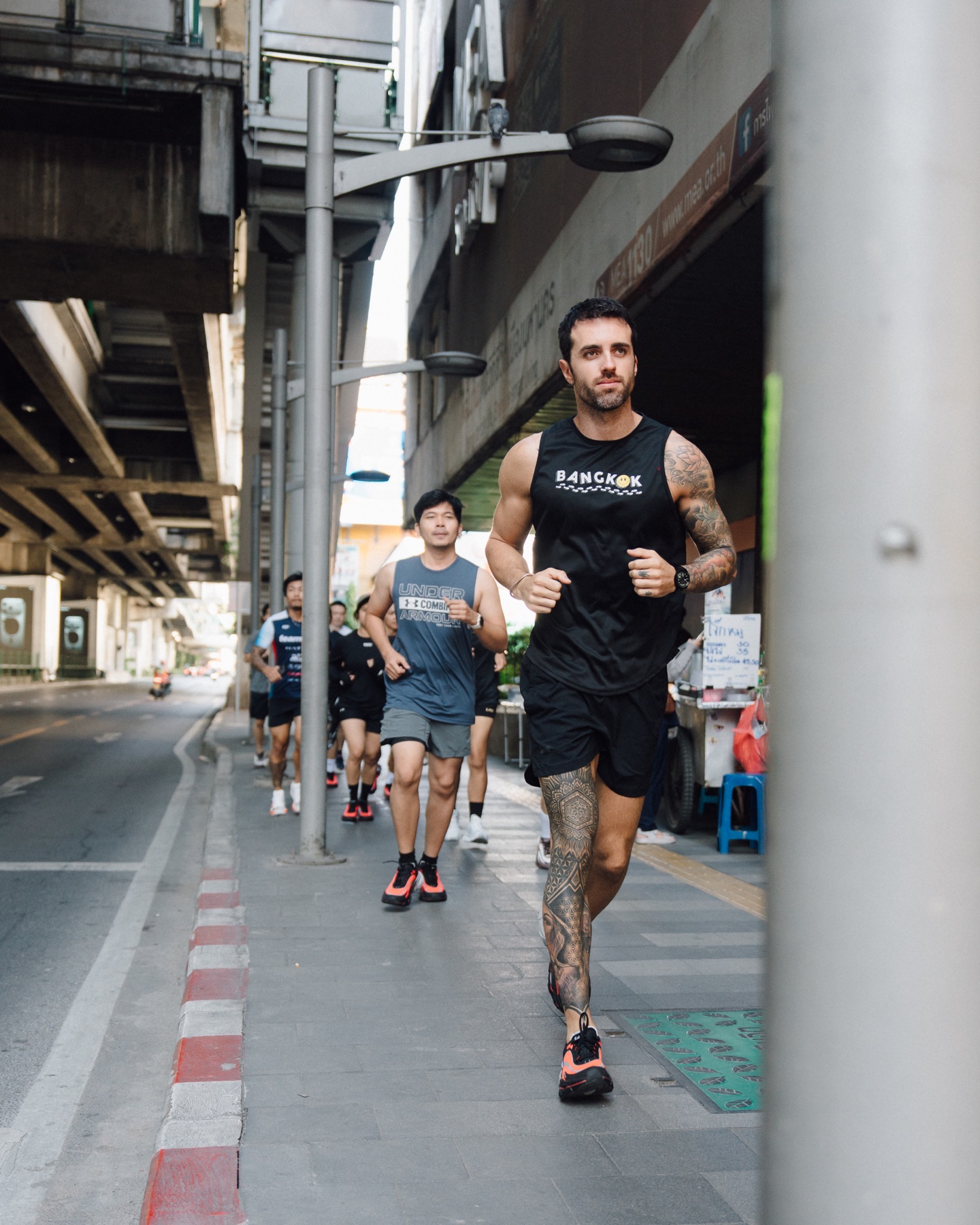 Luc leading a group run through Bangkok