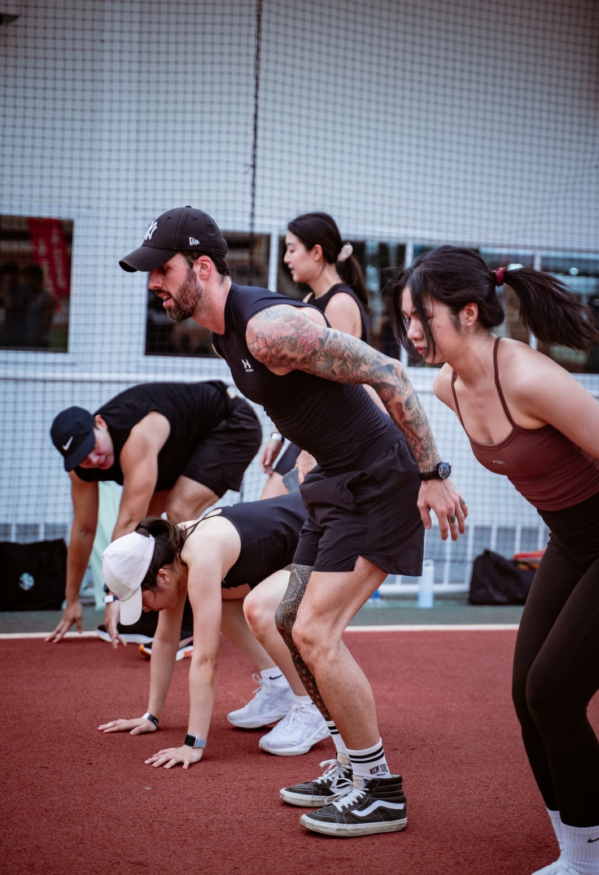 Luc coaching athletes through a track workout